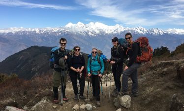Trekker overlooking the sacred Gosainkunda Lake surrounded by snow-capped peaks during the Langtang Gosainkunda Lake Trek in Nepal