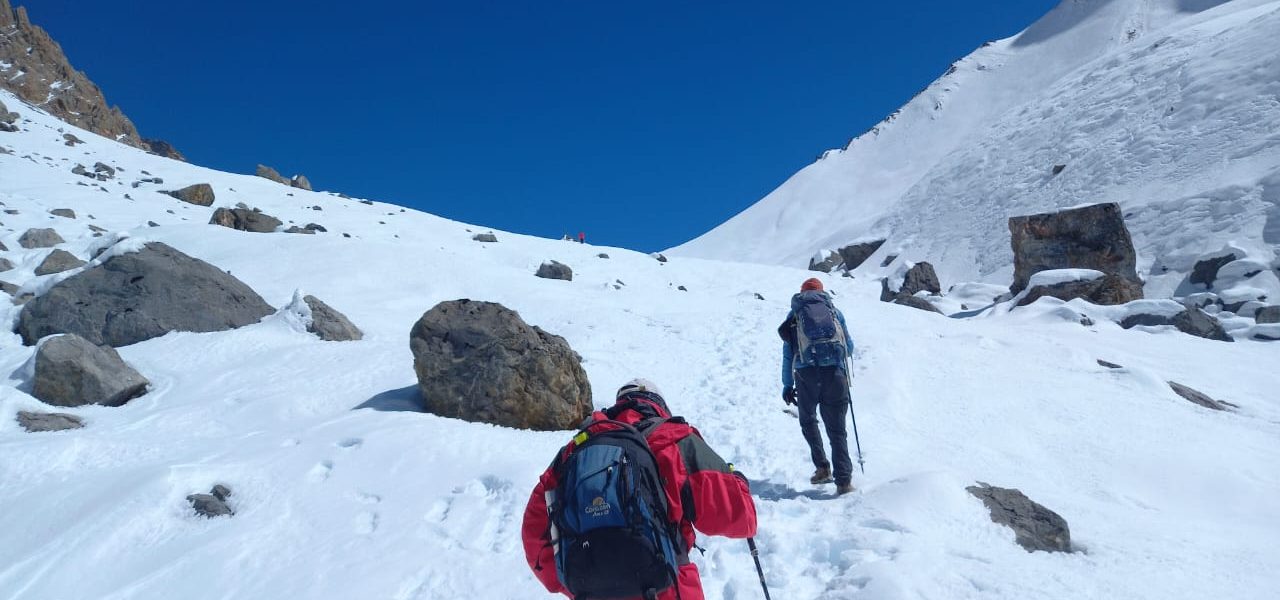 Trekkers walking through remote Buddhist villages of Tsum Valley with Mani walls, ancient monasteries, and snow-capped peaks in the background — hidden gem of the Manaslu region, Nepal.