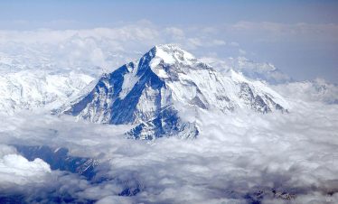 Trekkers crossing the high mountain pass with stunning views of Dhaulagiri Himal on the Dhaulagiri Circuit Trek in Nepa