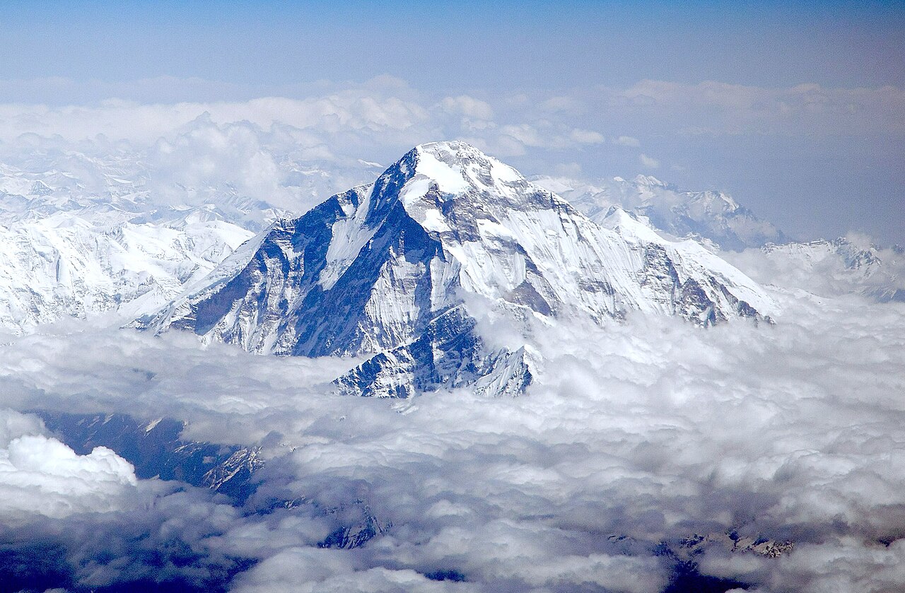 Trekkers crossing the high mountain pass with stunning views of Dhaulagiri Himal on the Dhaulagiri Circuit Trek in Nepa