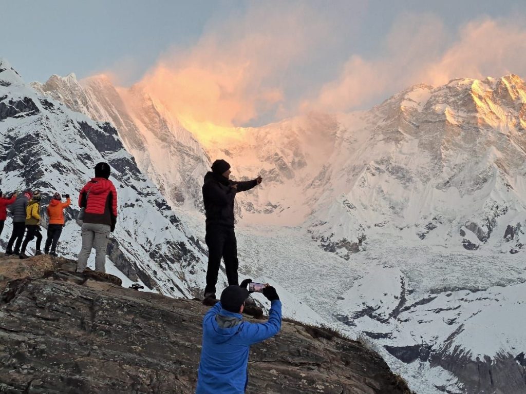 Trekkers walking through rhododendron forests towards Annapurna Base Camp with snow-capped peaks in view during the 11 Days Annapurna Base Camp Trek in Nepal
