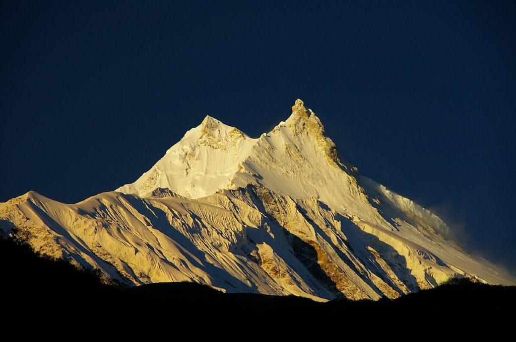 Climbers ascending the snowy slopes of Mount Manaslu, the eighth-highest mountain in the world, during the Manaslu Expedition in Nepal.”