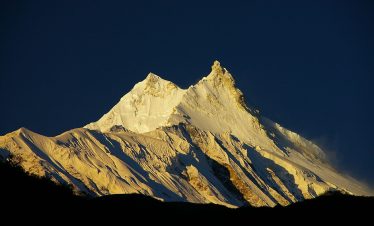 Climbers ascending the snowy slopes of Mount Manaslu, the eighth-highest mountain in the world, during the Manaslu Expedition in Nepal.”