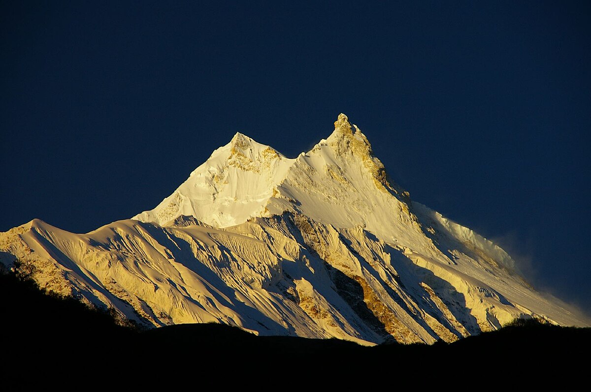 Climbers ascending the snowy slopes of Mount Manaslu, the eighth-highest mountain in the world, during the Manaslu Expedition in Nepal.”