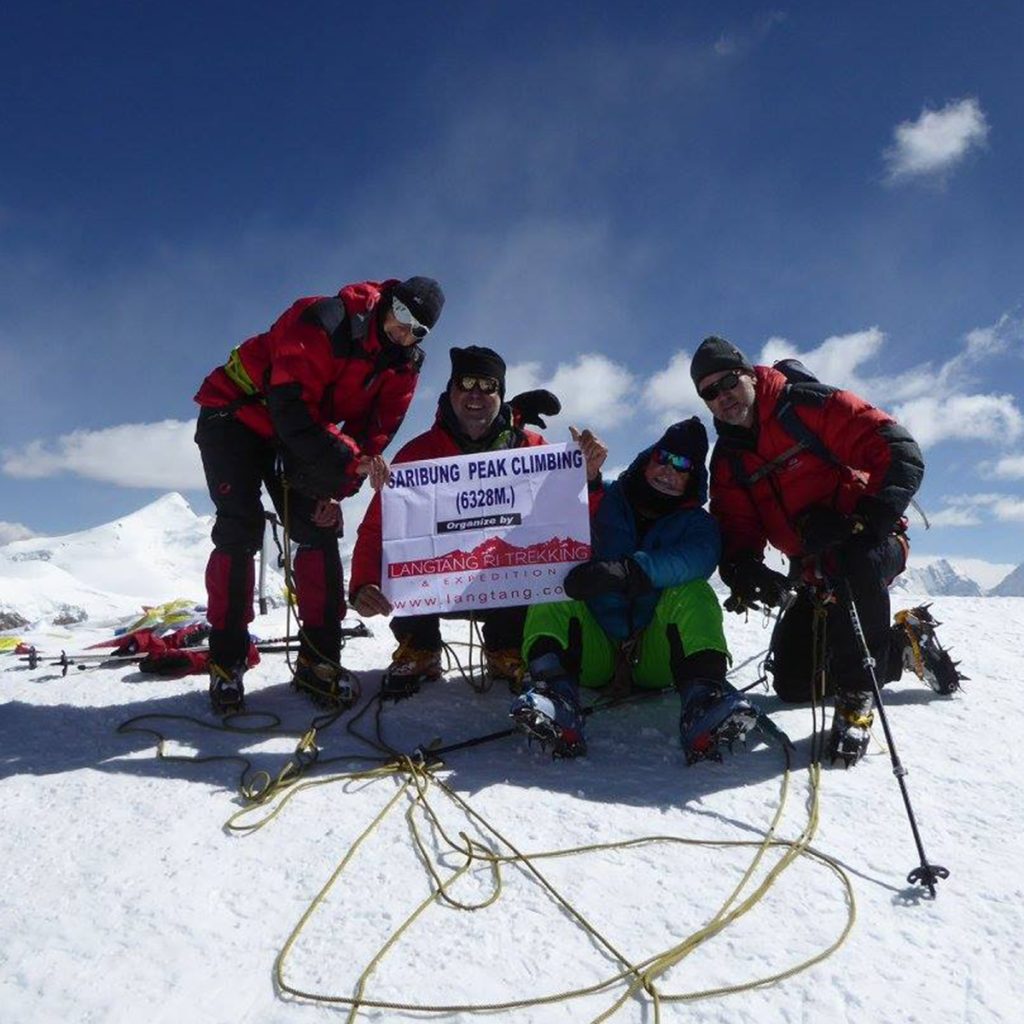 Climbers approaching the summit ridge of Saribung Peak (6,328m) surrounded by snow-covered peaks in the remote Upper Mustang region of Nepal during the Saribung Peak Expedition 2025.