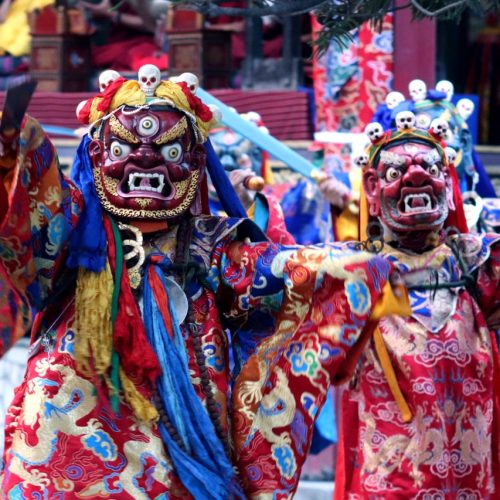 Colorful dancers in traditional costume at a Kathmandu festival.