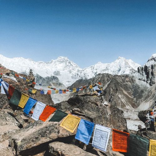 Vibrant prayer flags flutter amidst the majestic Himalayan mountains in Nepal.