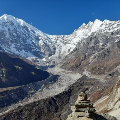 Stunning view of Langtang Lirung snow-capped peaks under clear blue sky.