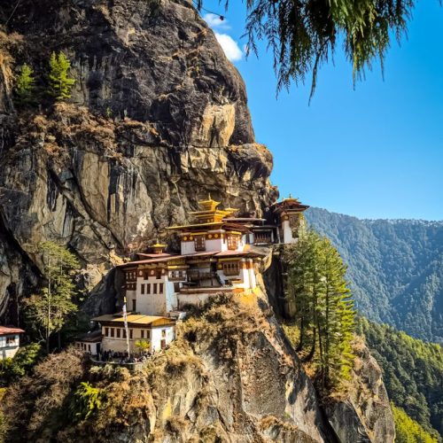 Capture of the iconic Tiger's Nest Monastery perched on a cliff in Paro, Bhutan, under a clear blue sky.