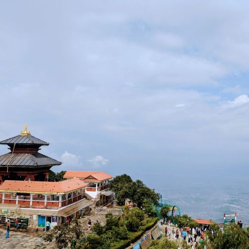 A stunning vista of a temple at Chandragiri Hills with lush greenery and panoramic views of the valley.